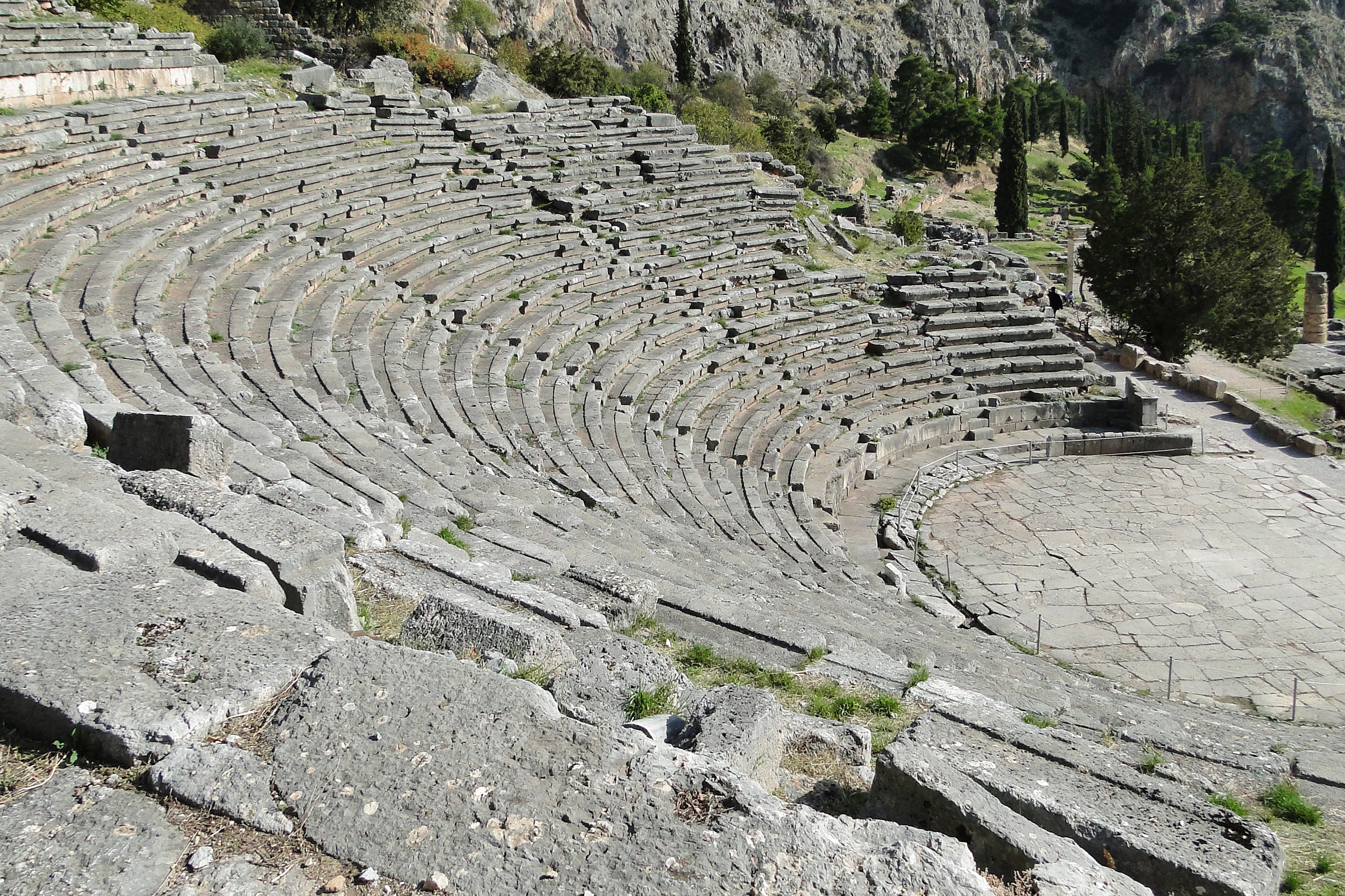 The ancient theatre of Delphi with the cliffs of Parnassos behind, Greece