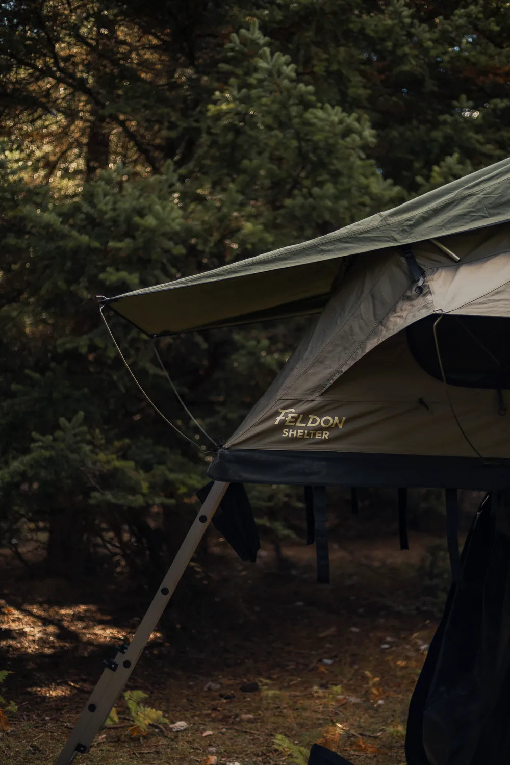 Close-up of the Feldon Shelter Crow's Nest soft-shell roof top tent and its ladder