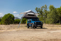 Blue Suzuki Jimny with the Feldon Shelter Crow's Nest roof top tent open at a forest camp