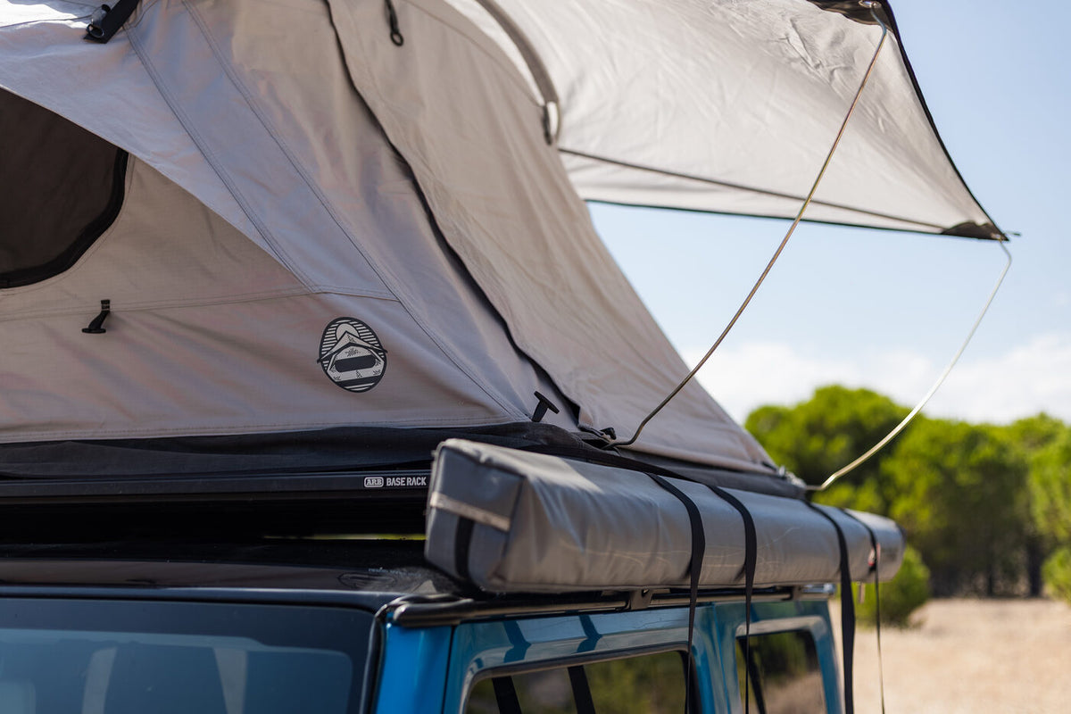 The Crow's Nest roof top tent open with its flysheet extended over the side